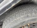 A close-up of a worn tire tread showcasing grooves and patterns typical of a 2005 Katolight SED60FPJ4 vehicle tire