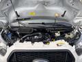 2021 Ford Transit-350 engine compartment with various components visible including the air intake and fluid reservoirs