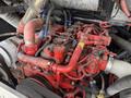 Close-up of a red engine with various hoses and components visible, showing intricate details of the mechanical parts and wiring