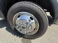 Close-up of a chrome wheel with a shiny hubcap mounted on a black tire of a 2011 Dodge Ram 5500