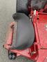 Close-up of a black rotary mower deck on a 2017 Ferris mower showing a curved shield and metal components adjacent to the wheel