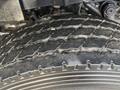 Close-up of the tire tread of a 2011 International WorkStar showing a rugged design with deep grooves and wear patterns