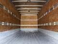 An empty truck interior of a 2014 International TerraStar featuring wooden walls and a metal floor