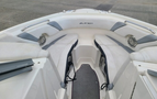 Interior seating area of a 2013 Larson 238 boat featuring cushioned benches and built-in speakers