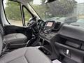 Interior view of a 2023 RAM Promaster 3500 showing two front seats a dashboard with a touchscreen display and controls