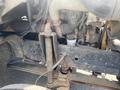Close-up view of the engine components and frame of a 1996 GMC Top Kick showcasing rusted metal parts and connections