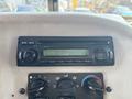 A car stereo and control panel featuring knobs for temperature and fan settings in a 2008 Peterbilt 340 truck cab