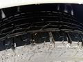 Close-up of a tire on a 2017 Mercedes-Benz Sprinter showing detailed tread pattern and water droplets on the surface