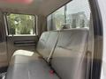 Interior view of a 2008 Ford F-550 showing the rear seat with a gray vinyl bench seat and a seatbelt