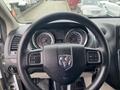 Steering wheel and dashboard of a 2014 RAM Cargo Van featuring speedometer and fuel gauge displays