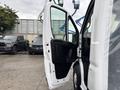 A white 2023 RAM Promaster 3500 with its driver's side door open showcasing the interior cabin space