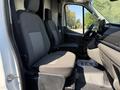 Interior of a 2022 Ford Transit showing two front seats and the dashboard with a steering wheel and display screen