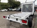 A 2023 RAM Promaster 3500 chassis with an open rear section and no cargo area showing the frame and wheels
