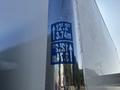 Close-up of a height clearance sign on a 2018 Hino 195 truck displaying measurements of 12 feet 2 inches and 3.74 meters on a reflective surface