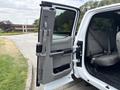 A 2018 Ford F-150 with an open front door revealing the interior seats and armrest