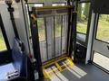 A wheelchair lift inside a 2020 Chevrolet Express van with a yellow platform and black mesh covering