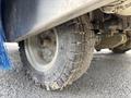 Close-up of a rugged tire from a 2023 Bitimec SC415 showcasing its tread pattern and metal rim