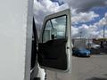 A 2022 International MV607 truck with the driver's side door open showcasing the interior and mirror