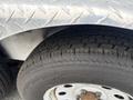 Close-up view of a tire from a 2016 Continental cargo trailer featuring a patterned tread and metallic rim