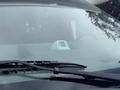 A 2020 Chevrolet Express with a white dashboard device visible through the windshield