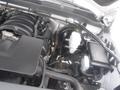 Under the hood of a 2015 Chevrolet Silverado 1500 revealing the engine components including the air intake manifold and various hoses and electrical connections