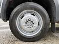 Close-up of a 2007 Ford F-550 wheel showing a silver rim and a heavy-duty tire with the brand name Roadmaster and tread pattern visible