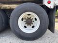 A close-up view of a tire mounted on a wheel from a 2011 Autocar Xpeditor showing the Continental branding and the wheel hub with visible bolts