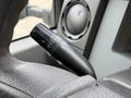 Close-up of a 2015 Ford F-350 windshield wiper control lever with labeled settings for off, intermittent, low, and high speeds