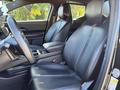 Interior view of a 2023 Fisker Ocean showing two front seats with black leather upholstery and a modern dashboard design