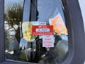 2011 Freightliner M2 106 with a visible certificate of approval sticker on the window displaying the month and year