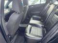Interior view of a 2015 Dodge Charger showing black leather seats in the back row
