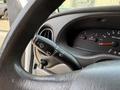 Close-up view of the steering wheel and dashboard controls in a 2008 Ford Econoline showing the wiper and headlight controls