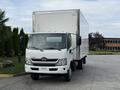 A white 2020 Hino 195 box truck with a large cargo area and dual side mirrors parked on a paved surface