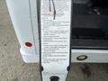 A 2013 Chevrolet Express with an accessible ramp and instructions for operating the wheelchair platform displayed on the side of the vehicle