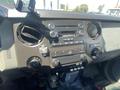 The interior dashboard of a 2016 Ford F-350 SD featuring a radio display knobs and controls for climate and media functions