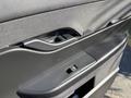 Close-up of the interior door handle and control panel of a 2023 Fisker Ocean featuring a sleek design and modern materials