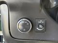 Close-up of the dashboard controls in a 2017 Chevrolet Express featuring a headlight switch and a dome light control button
