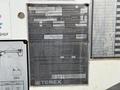 A metal information plate with details about a 2020 International MV607 including model name capacity ratings and operational instructions