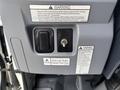 Dashboard of a 2015 Mitsubishi Fuso FE160 featuring warning labels a switch and a key ignition for DPF cleaning and fuel type information