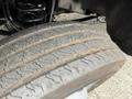 Close-up of the worn tire tread of a 2020 Ford F-550 showing visible grooves and dirt buildup on the tire surface