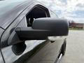 Close-up of the side mirror of a 2018 RAM 1500 showcasing its sleek design and integrated turn signal panel