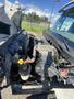 Engine compartment of a 2014 International 7400 showcasing various components including the engine block hoses and fluid reservoirs