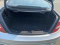 A 2013 Mercedes-Benz C-Class with an open trunk showcasing a spacious, empty cargo area