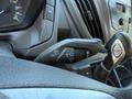 Close-up of the steering wheel controls of a 2015 Ford Transit showing buttons for wipers turn signals and vehicle functions