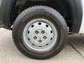 Close-up of a silver wheel with a RAM logo on a 2020 RAM Promaster tire showing tread pattern and valve stem