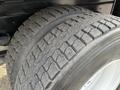 Close-up of a treaded tire on a 2011 International 4300 with visible wear and a robust design for heavy-duty performance