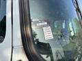 A close-up of the windshield of a 2011 Autocar Xpeditor featuring a certificate of approval sticker with months listed and a registration number
