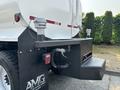 A black 2016 Freightliner M2 106 truck with a white tank attached to the back featuring hoses and fittings on the rear of the truck