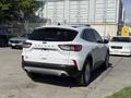 A white 2020 Ford Escape parked with its rear view visible showing the taillights and sporty design without any visible license plate