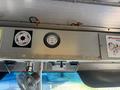 Interior dashboard of a 2012 Ford Econoline featuring gauges and switches along with a small fan